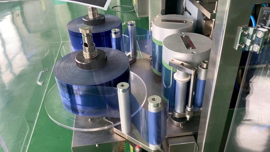 Automatic blister machine forming unit-dose plastic bottles from two film rolls
