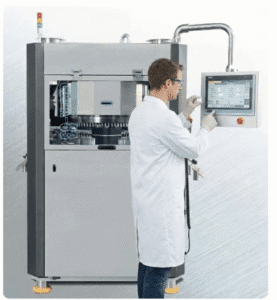 Operator adjusting settings on a user-friendly automatic pill presser.